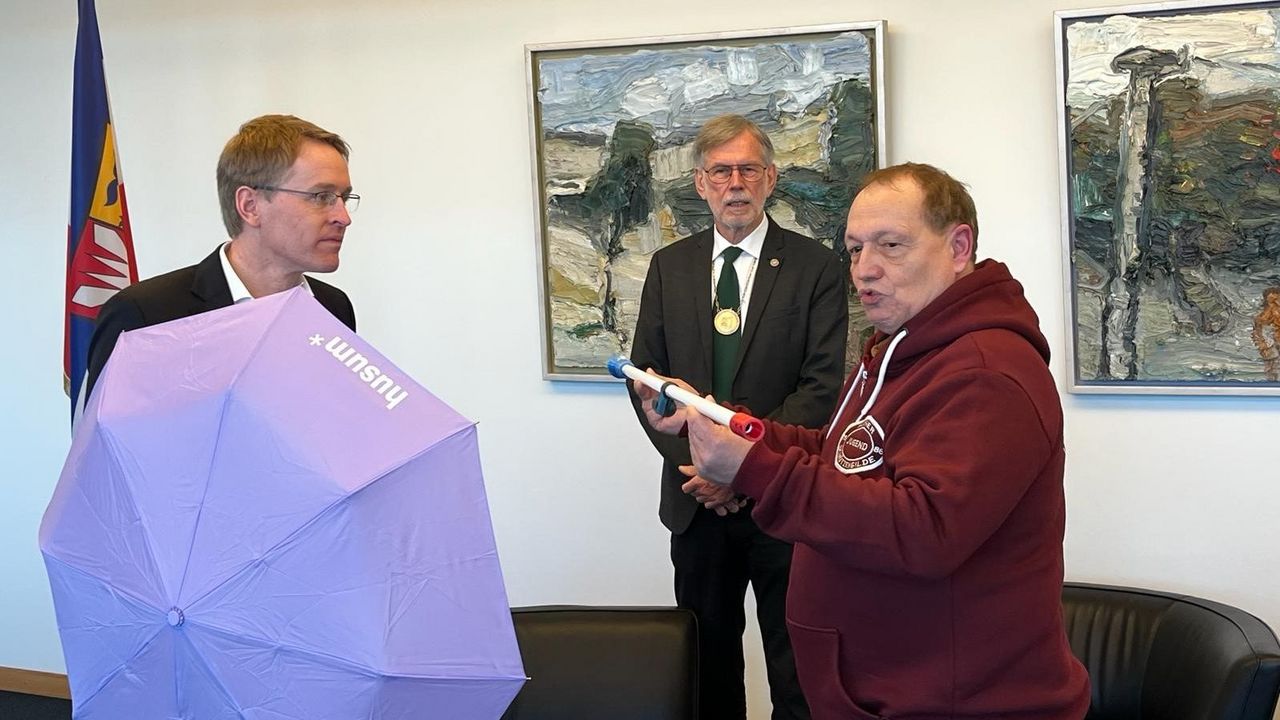 Foto: Staatskanzlei SH / Thilo Berg überreichte dem Schirmherrn des Kinder-Hilfe-Cups 2024, Ministerpräsident Daniel Günther, ein Blasrohr in den Farben Schleswig-Holsteins. Mit dabei Alfred Mordhorst.