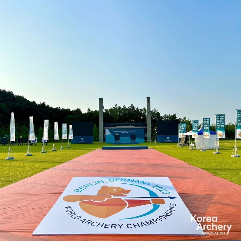Foto: Korea Archery Association / Die Koreaner überlassen nichts dem Zufall und bereiten die WM in Berlin akribisch mit Flaggen, WM-Logo sowie Nachbau der Türme inklusiver olympischer Ringe vor dem Berliner Olympiastadion vor.